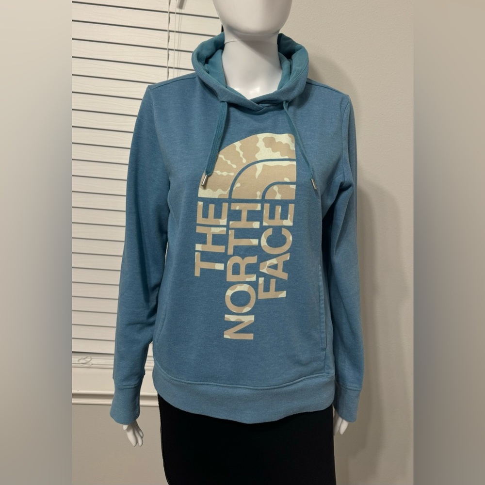 The North Face Wonen’s long-sleeve with hoodie. blue.  logo, size M. Two front
